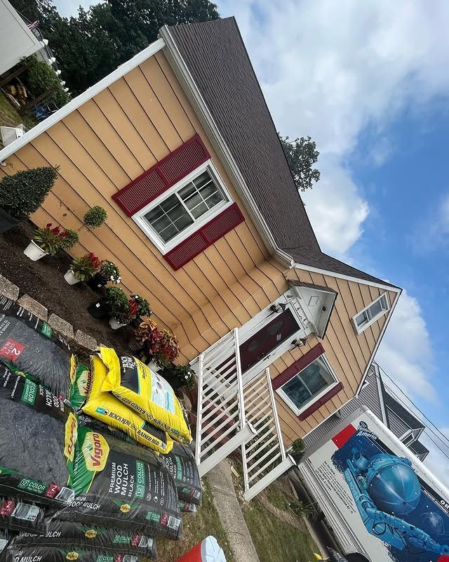 A house with a lot of bags of dirt in front of it