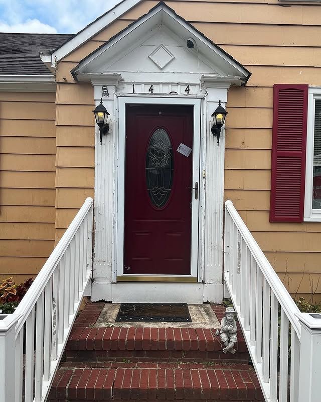 A house with a red door and a white railing