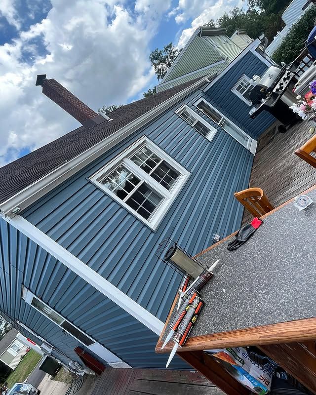 A blue house with a table and chairs in front of it