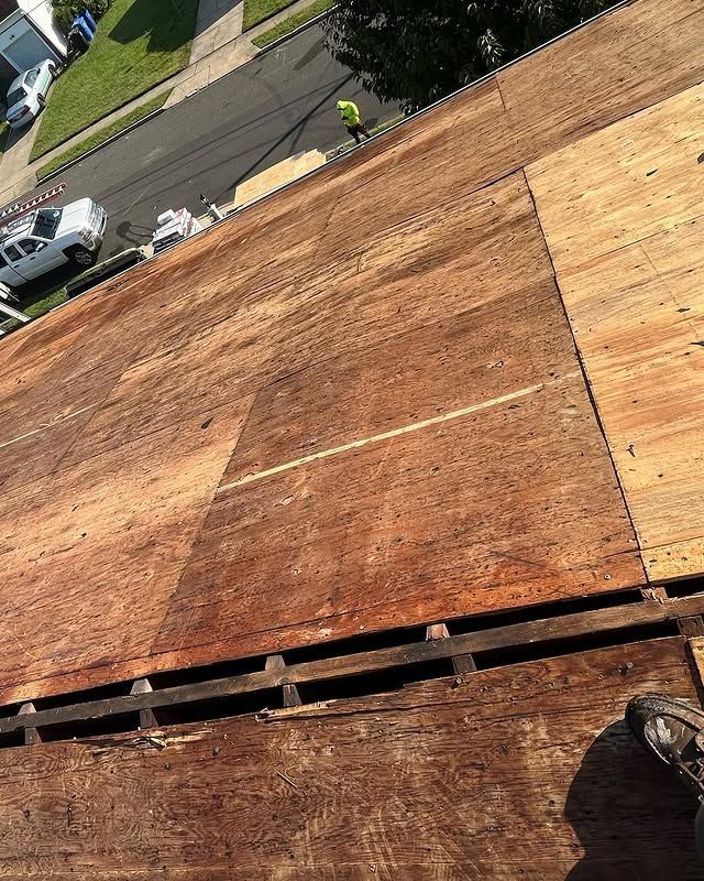 A roof with a lot of wood on it is being repaired.