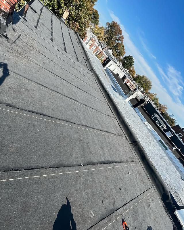 A black roof with a river in the background