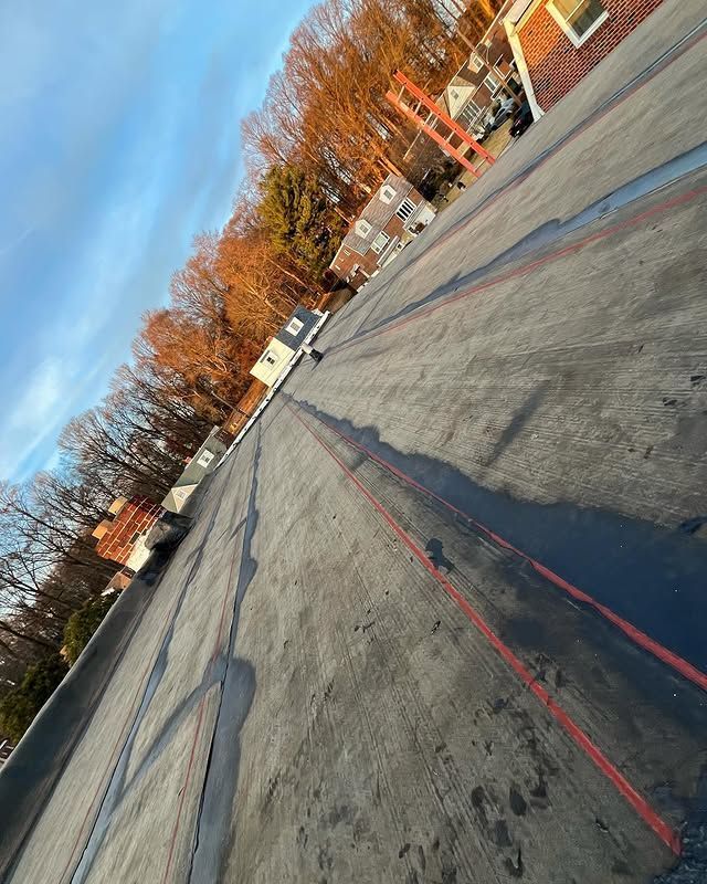 A car is driving down a road with a red line on it.