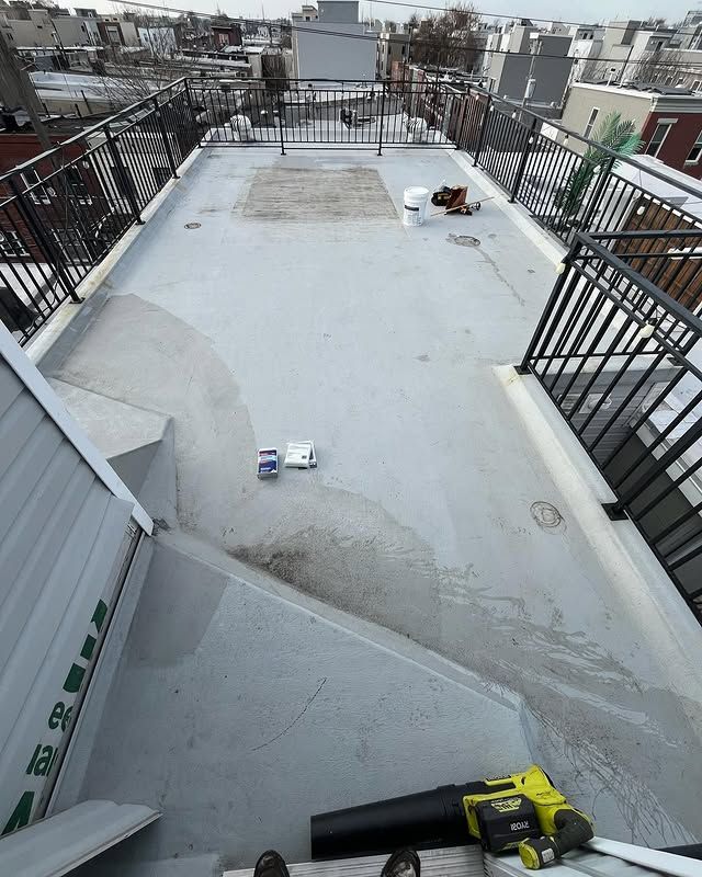 A rooftop with a staircase and a blower on it