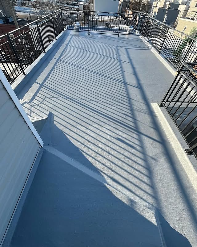 A balcony with a railing and a shadow on the floor.