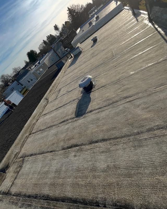 A close up of a roof with a fan on it.