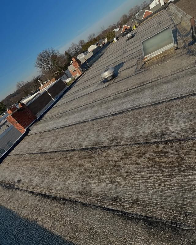 A roof of a building with a blue sky in the background