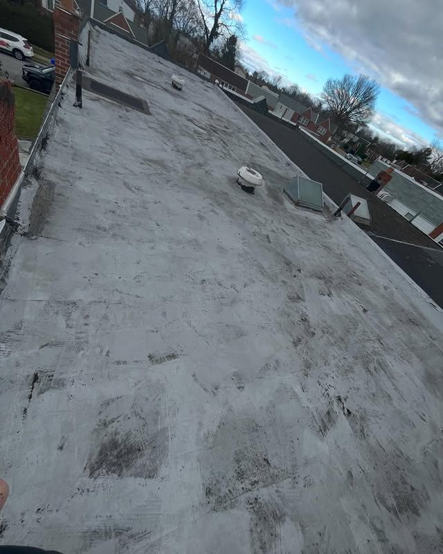 A person is standing on the roof of a building.