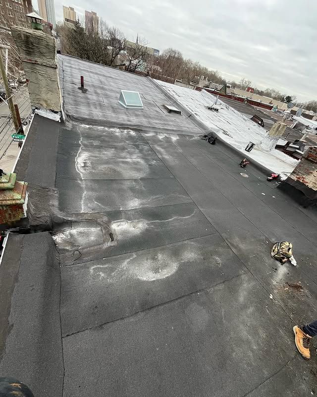 An aerial view of a roof with a skylight on it.