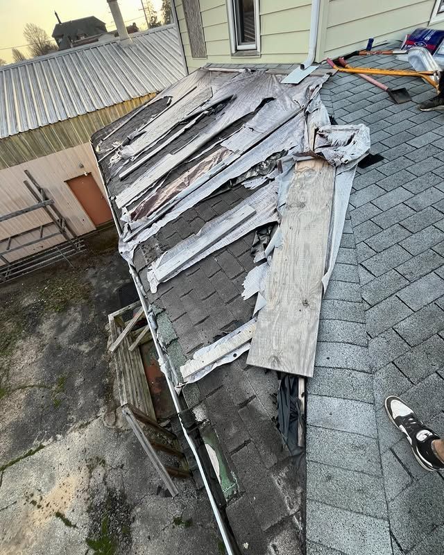 A roof that has been damaged by a storm and is being repaired.