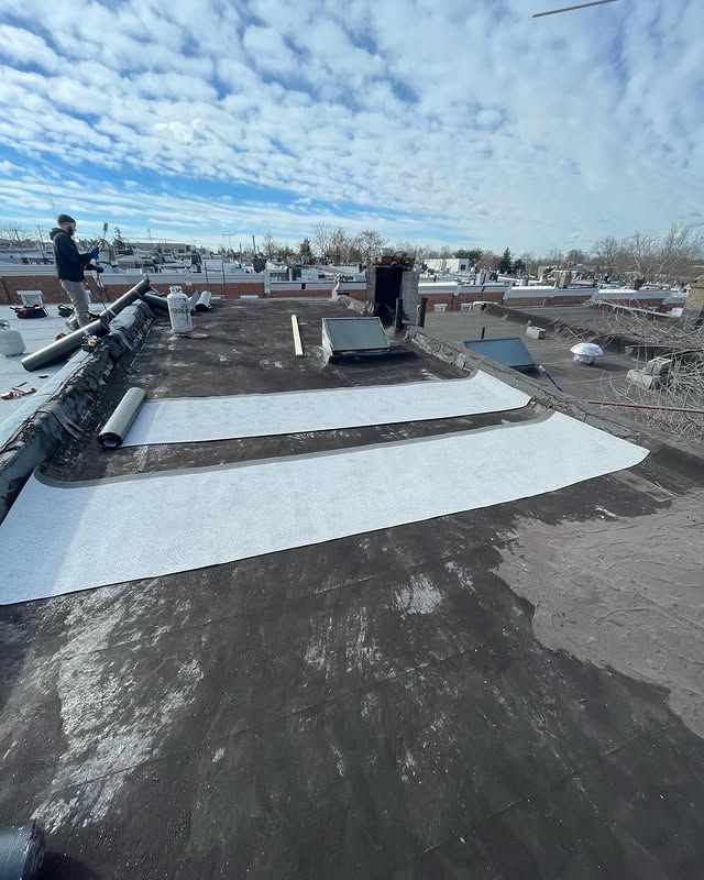 A man is standing on the roof of a building.