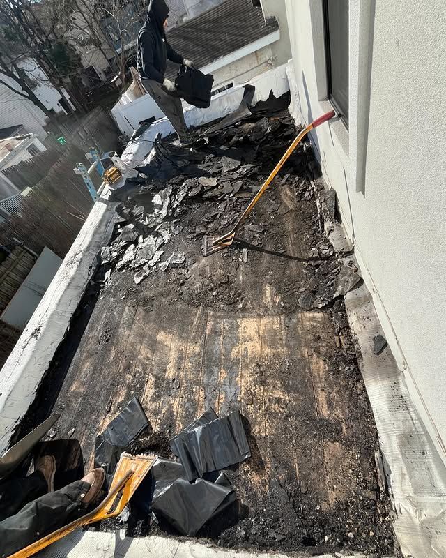 A man is working on the roof of a building.