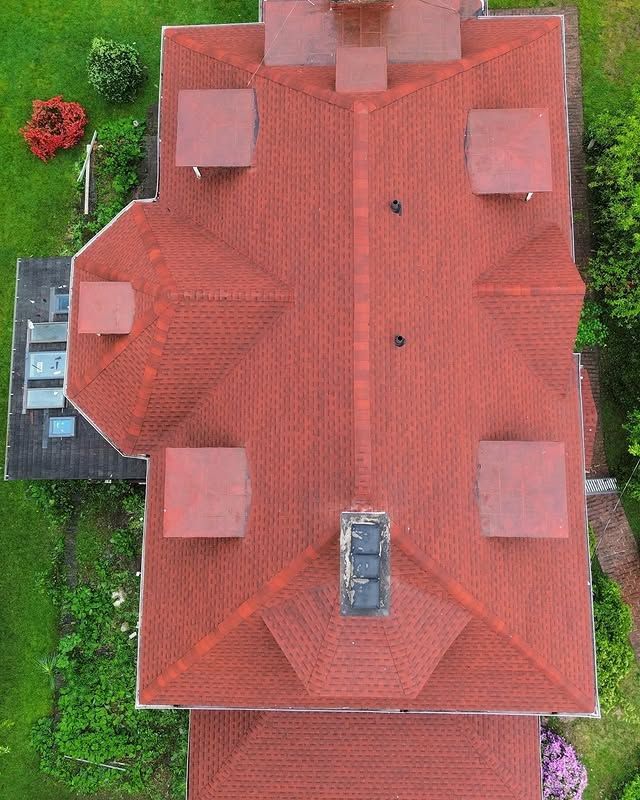 An aerial view of a house with a red roof