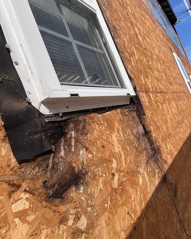 A close up of a window on the side of a house.
