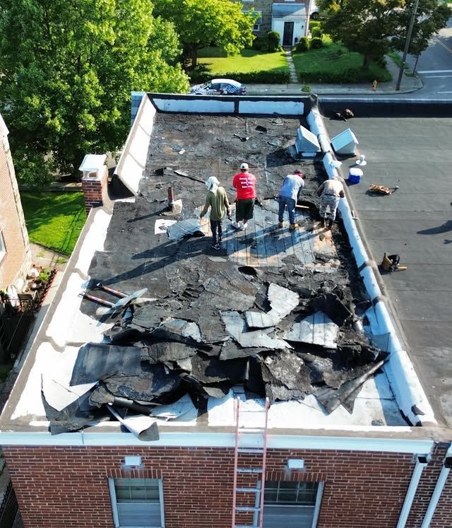 A group of people are working on the roof of a building.