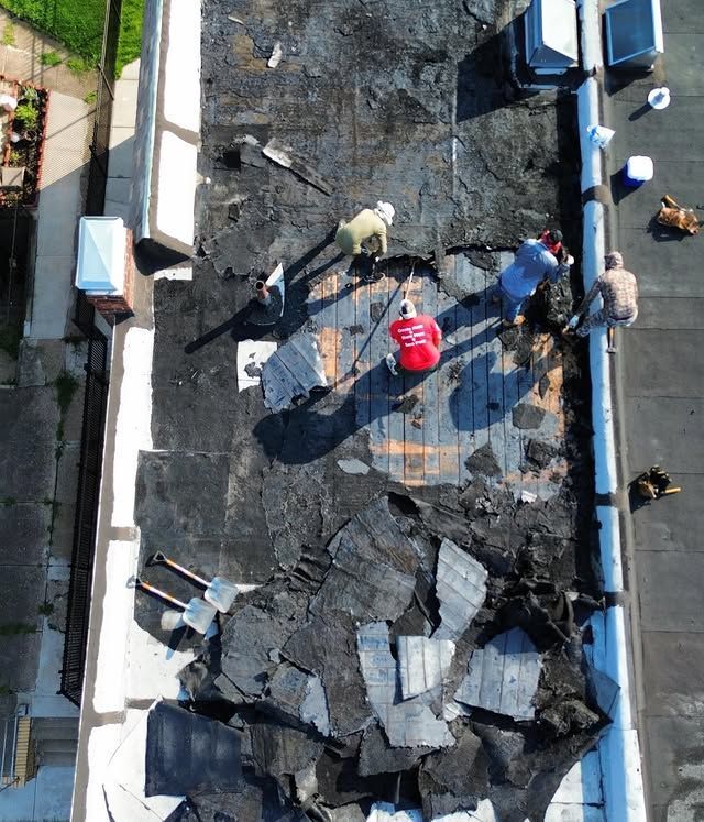 An aerial view of a group of people working on a roof