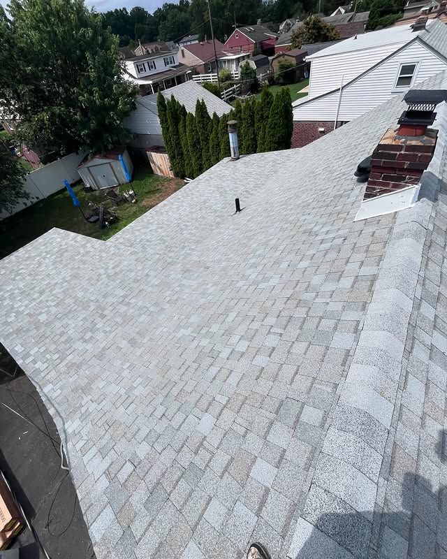 A person is standing on the roof of a house.