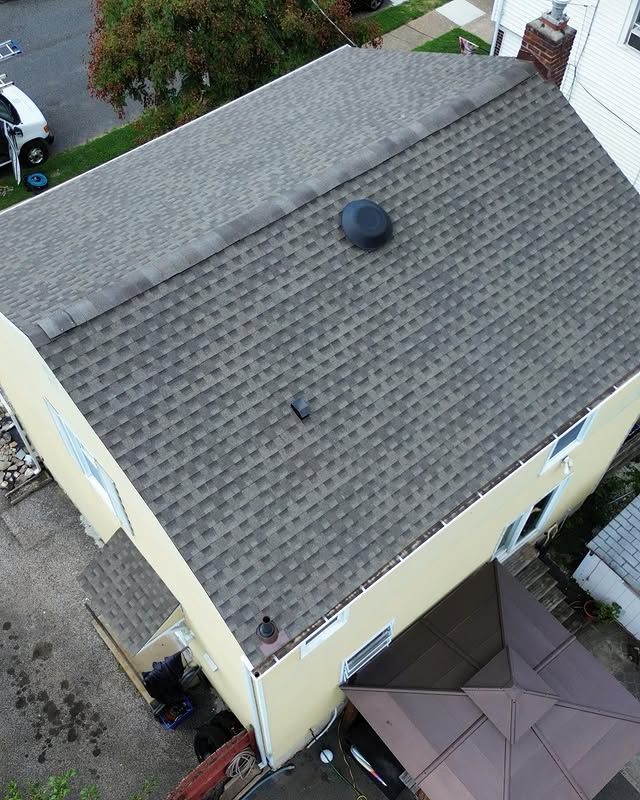 An aerial view of a house with a new roof.