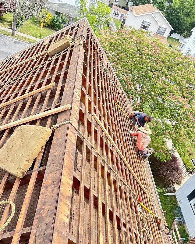 A group of men are working on the roof of a building.
