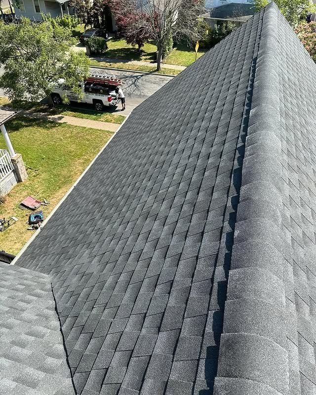 An aerial view of a roof of a house in a residential area.