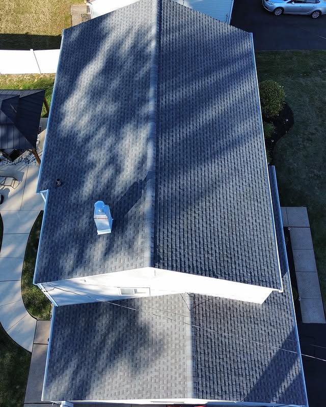 An aerial view of a house with a black roof