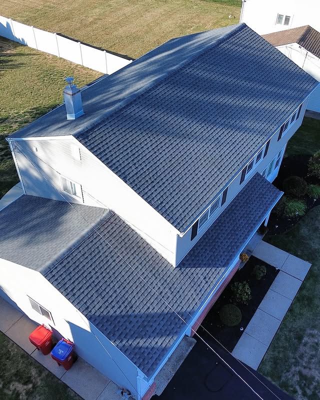 An aerial view of a house with a gray roof