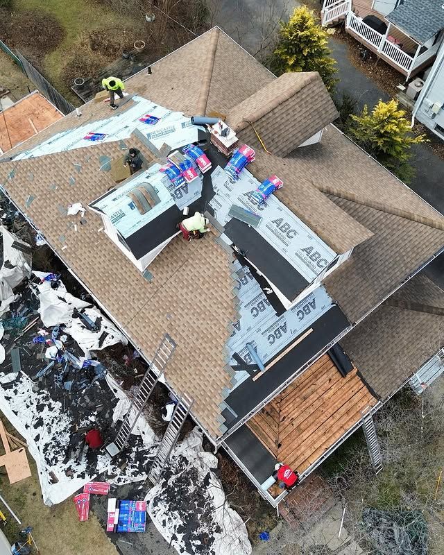 An aerial view of a roof being installed on a house.