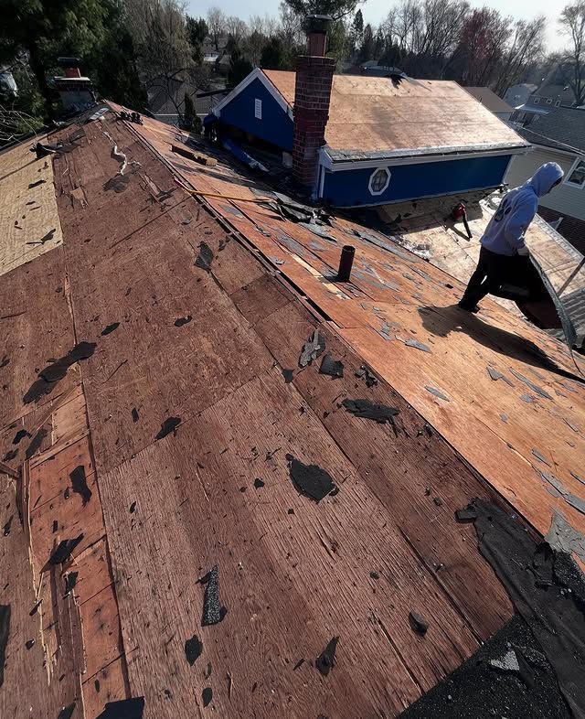 A man is working on the roof of a house.