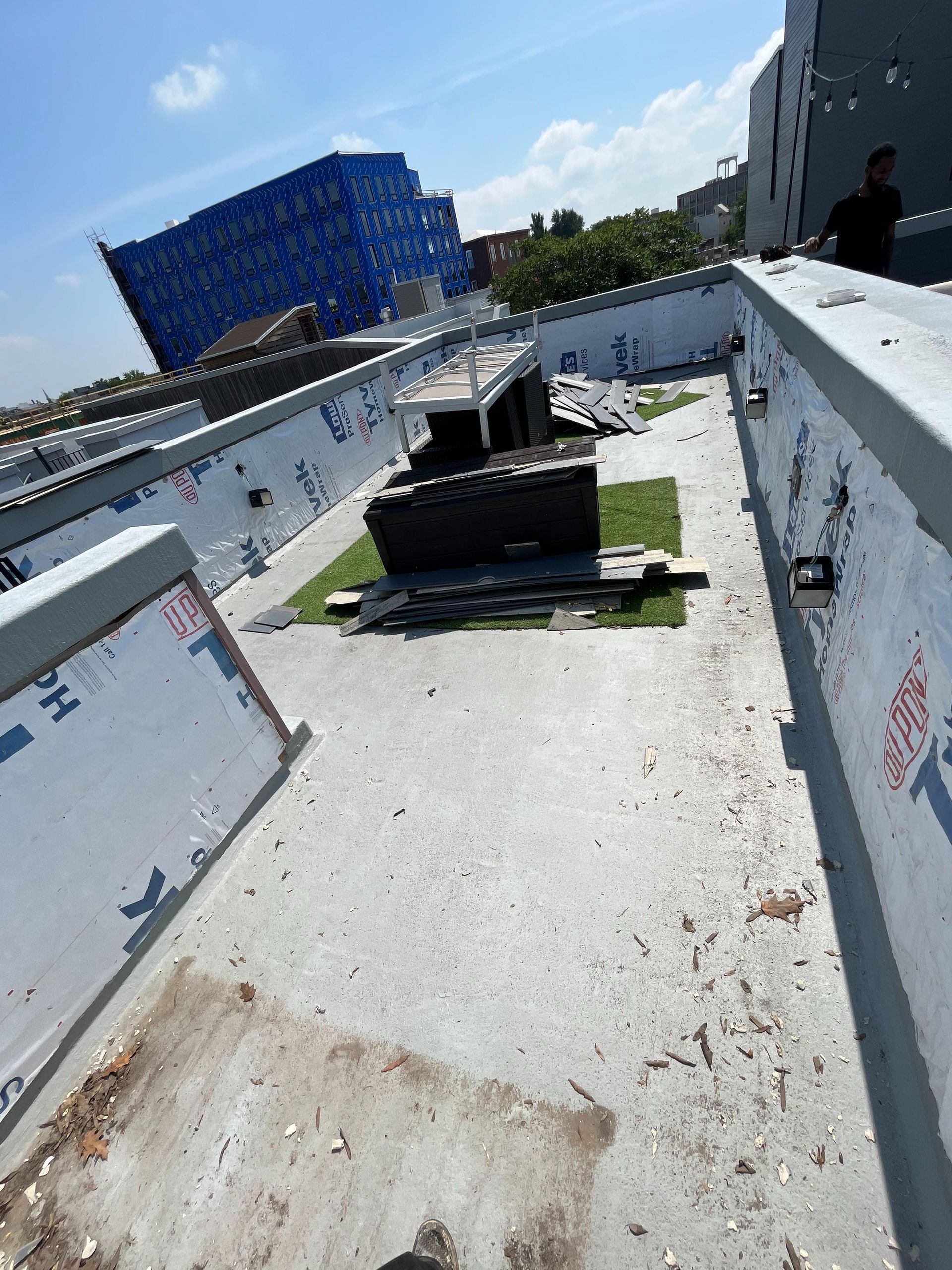 A concrete walkway with a blue building in the background