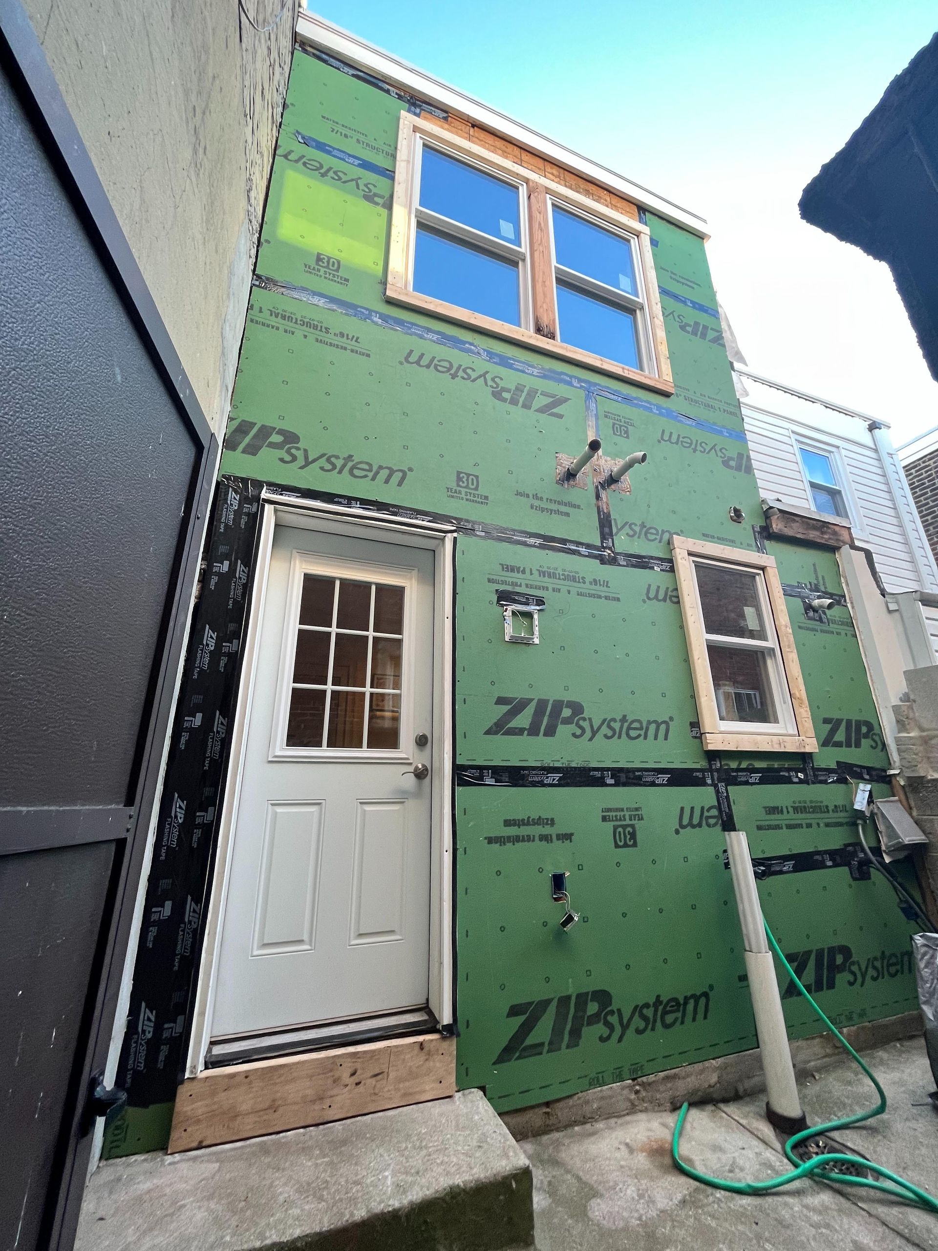 A house with a door and windows is being remodeled.