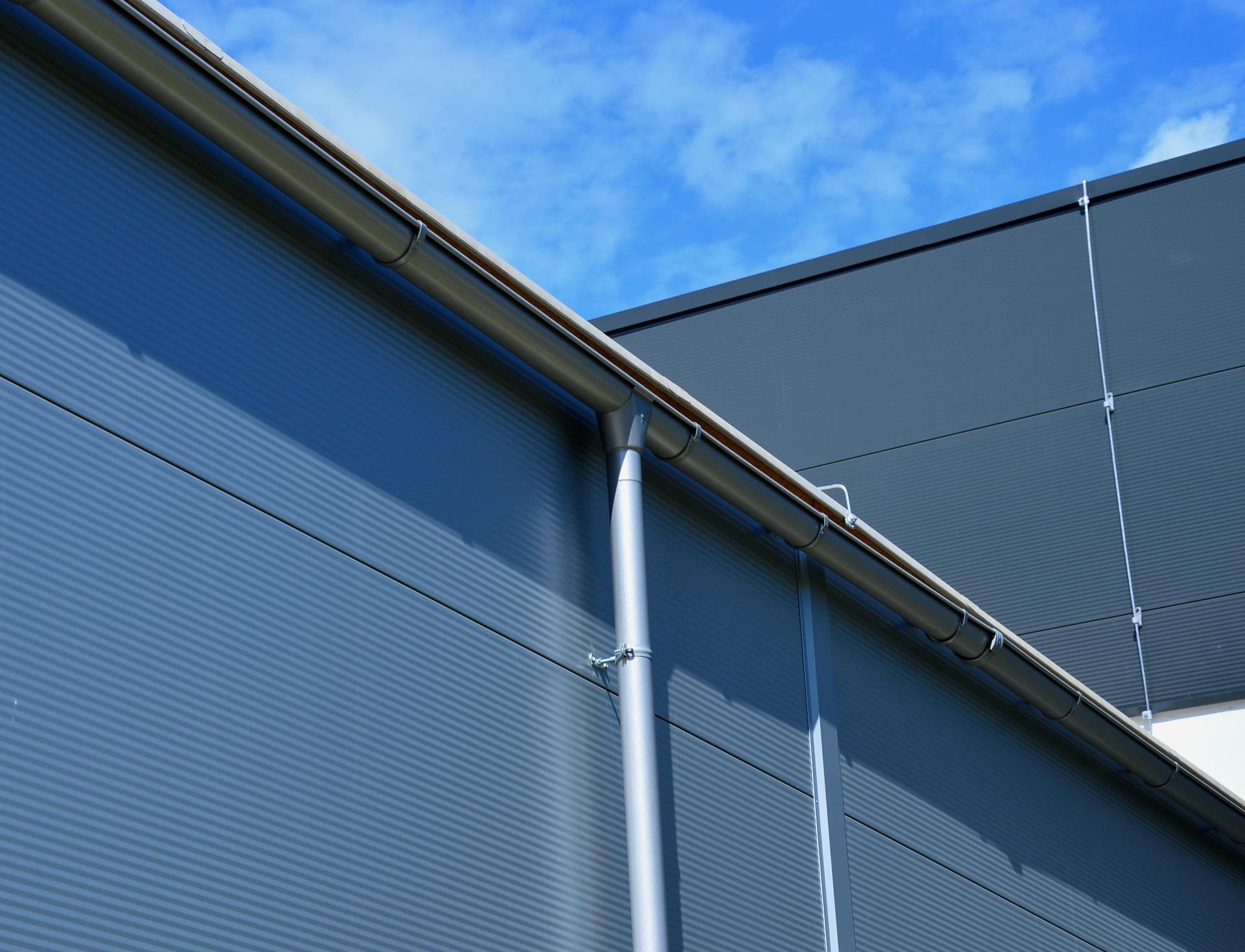 A gray building with a blue sky in the background