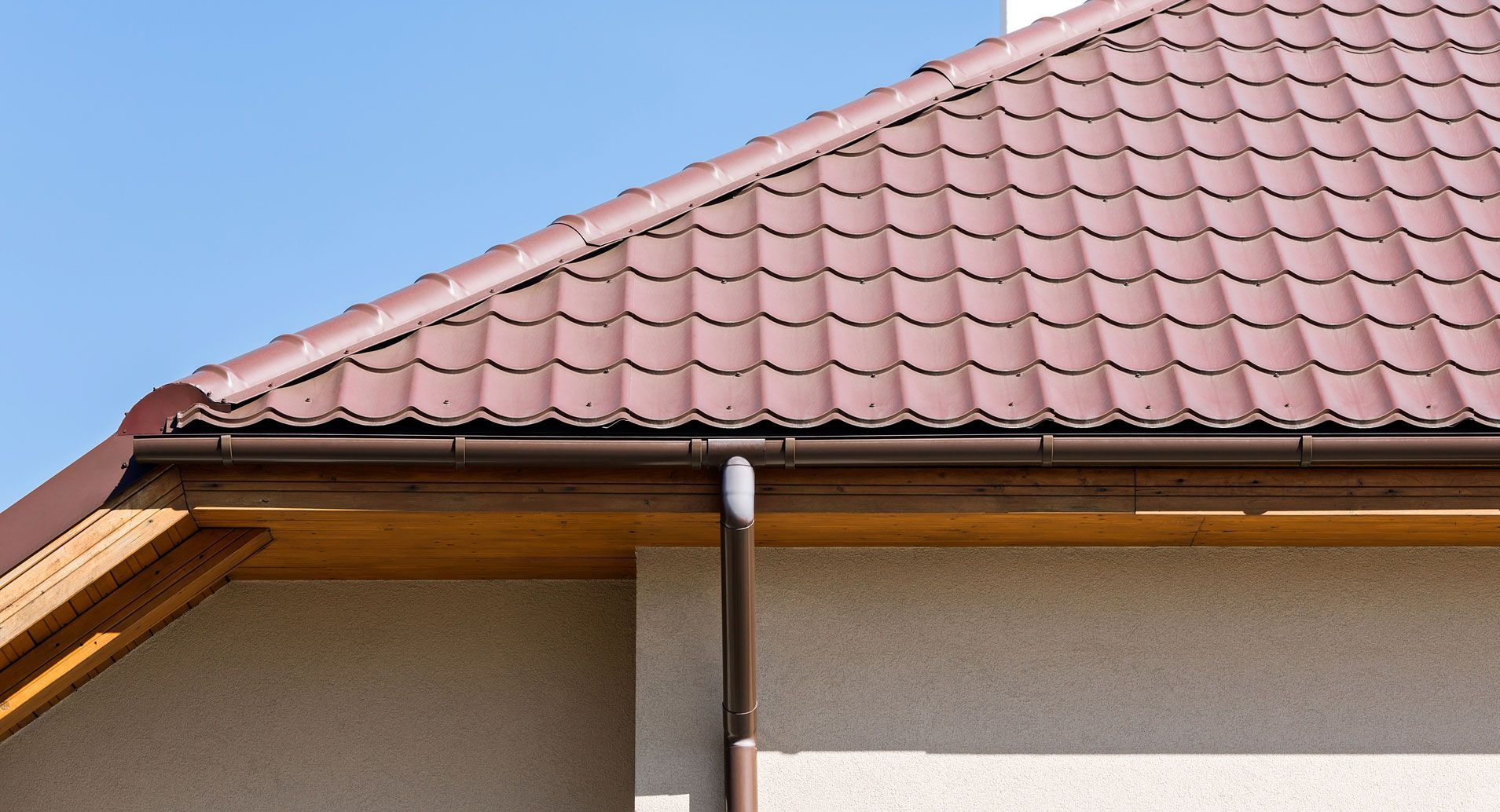 A house with a brown roof and a brown gutter