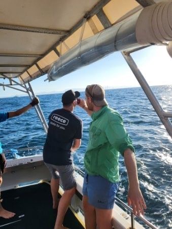 One of our boys ensuring the other is hydrated while reeling in a big fish!