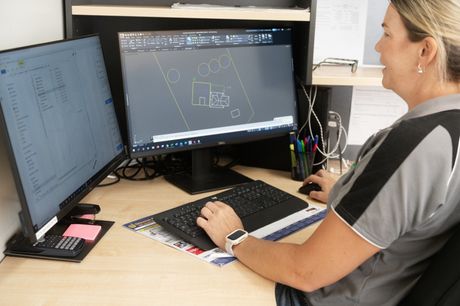 Kylie from HC Plumbing drafting designs for sewage system