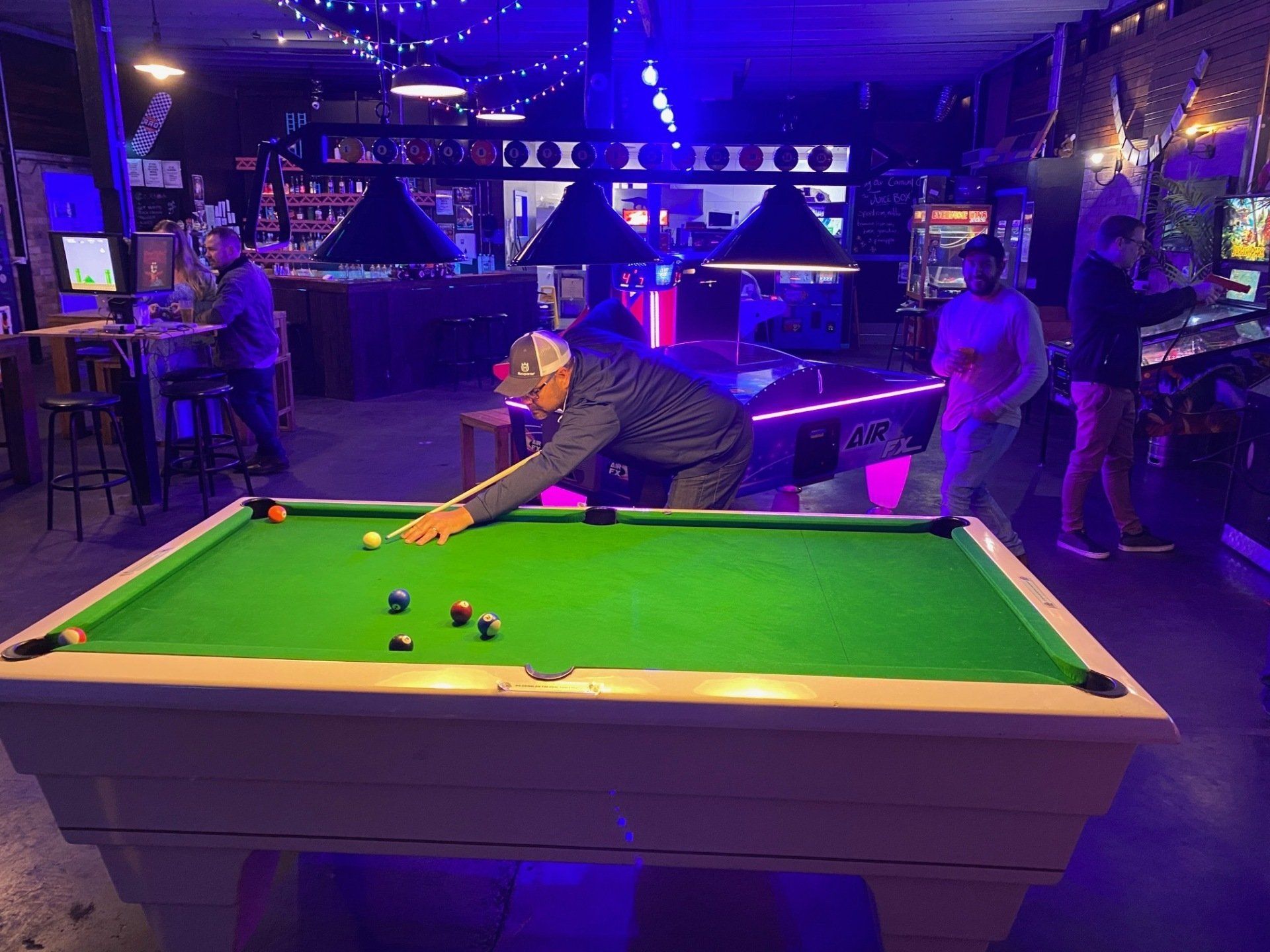 Man taking a shot on a pool table at Flipp'd Toowoomba