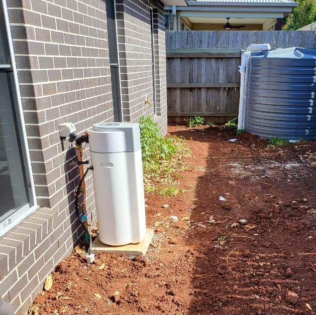 A water softening unit installed to a residential home.