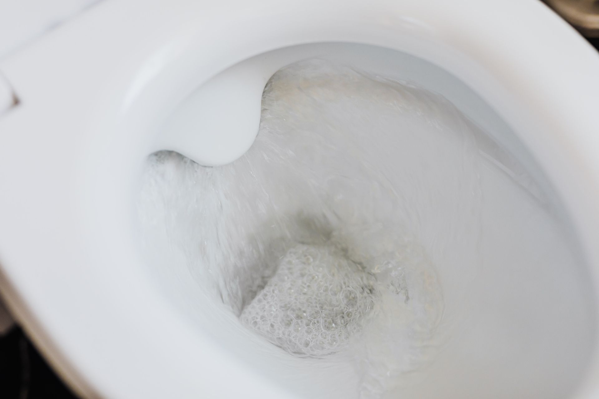A picture of the inside of a flushing toilet bowl