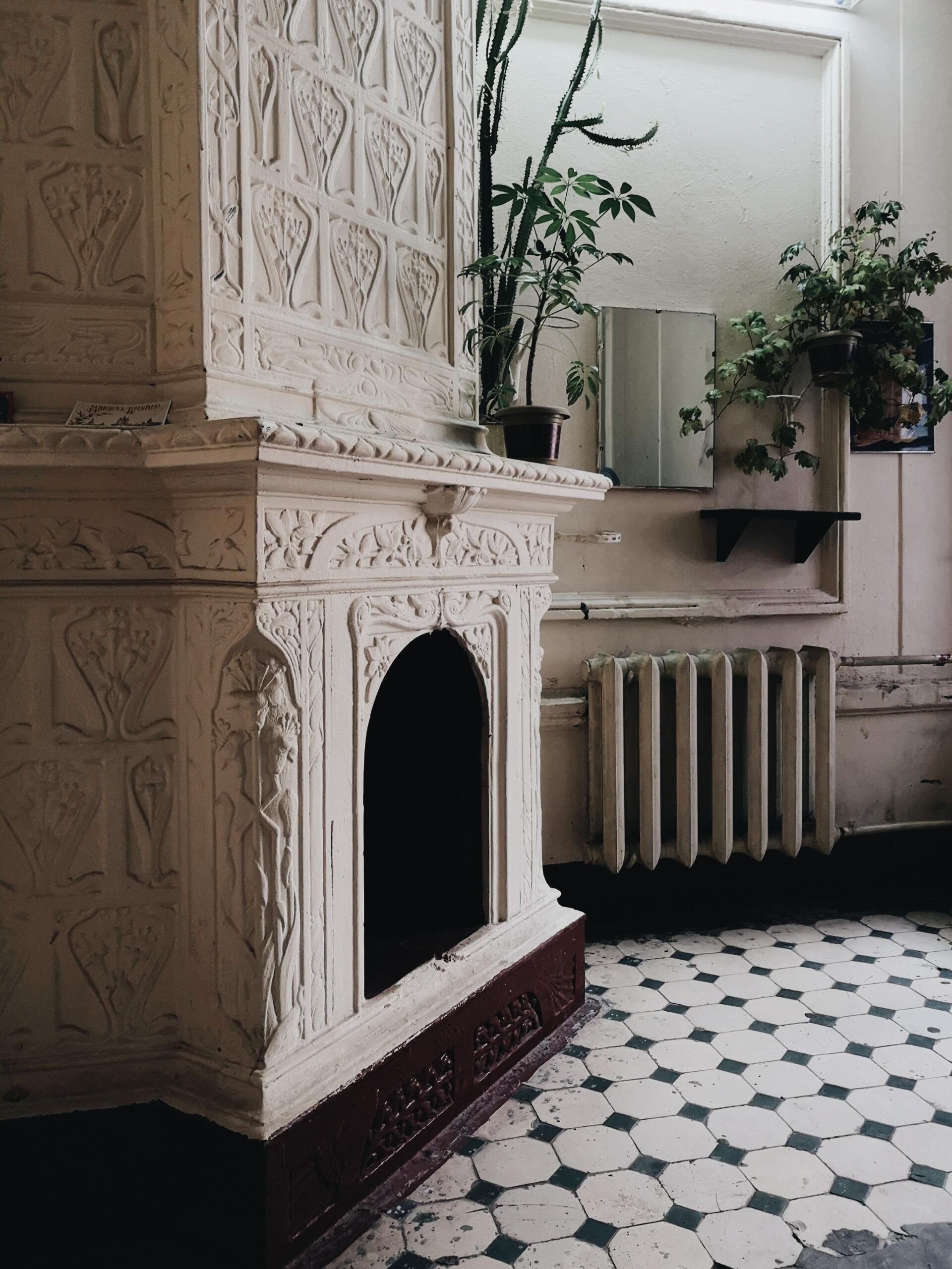 Old home with a stately fireplace and rusted old radiator