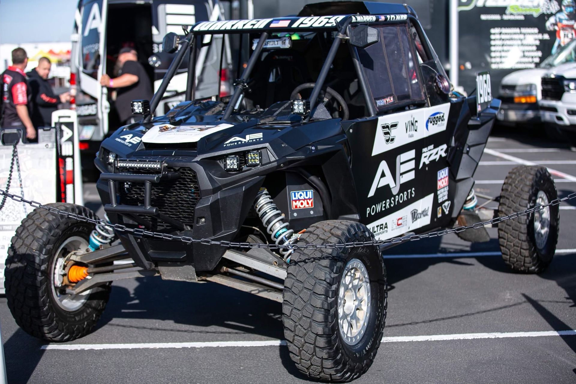 A black and white atv is parked in a parking lot.