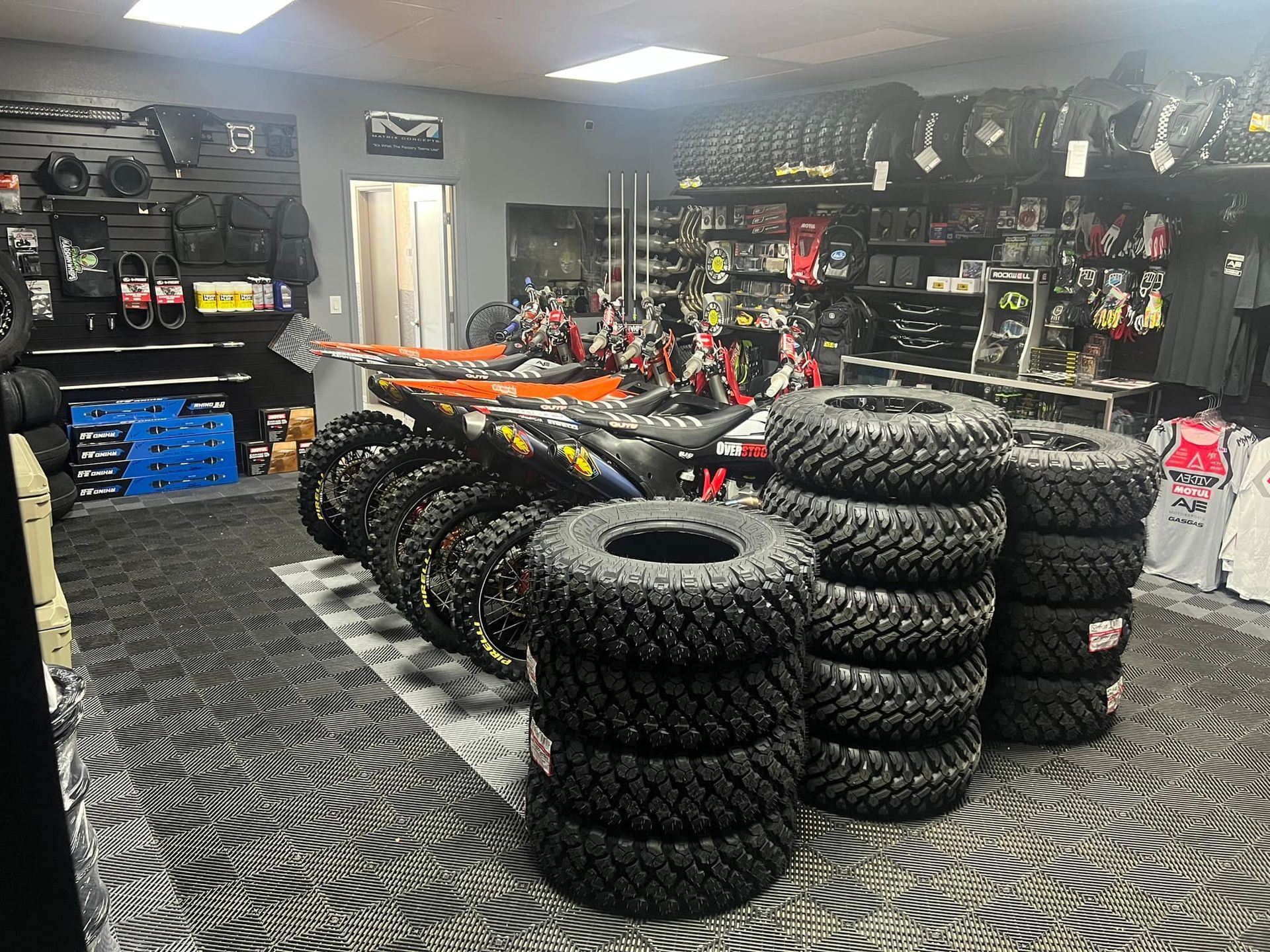 A bunch of tires are stacked on top of each other in a store.