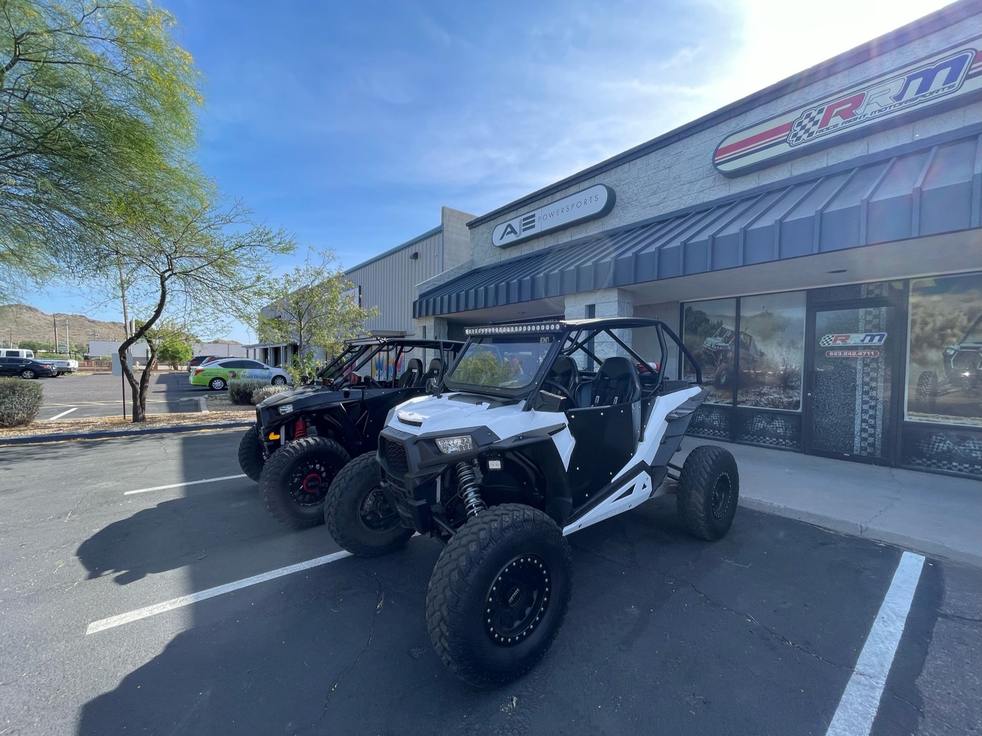 Three atvs are parked in front of a building.