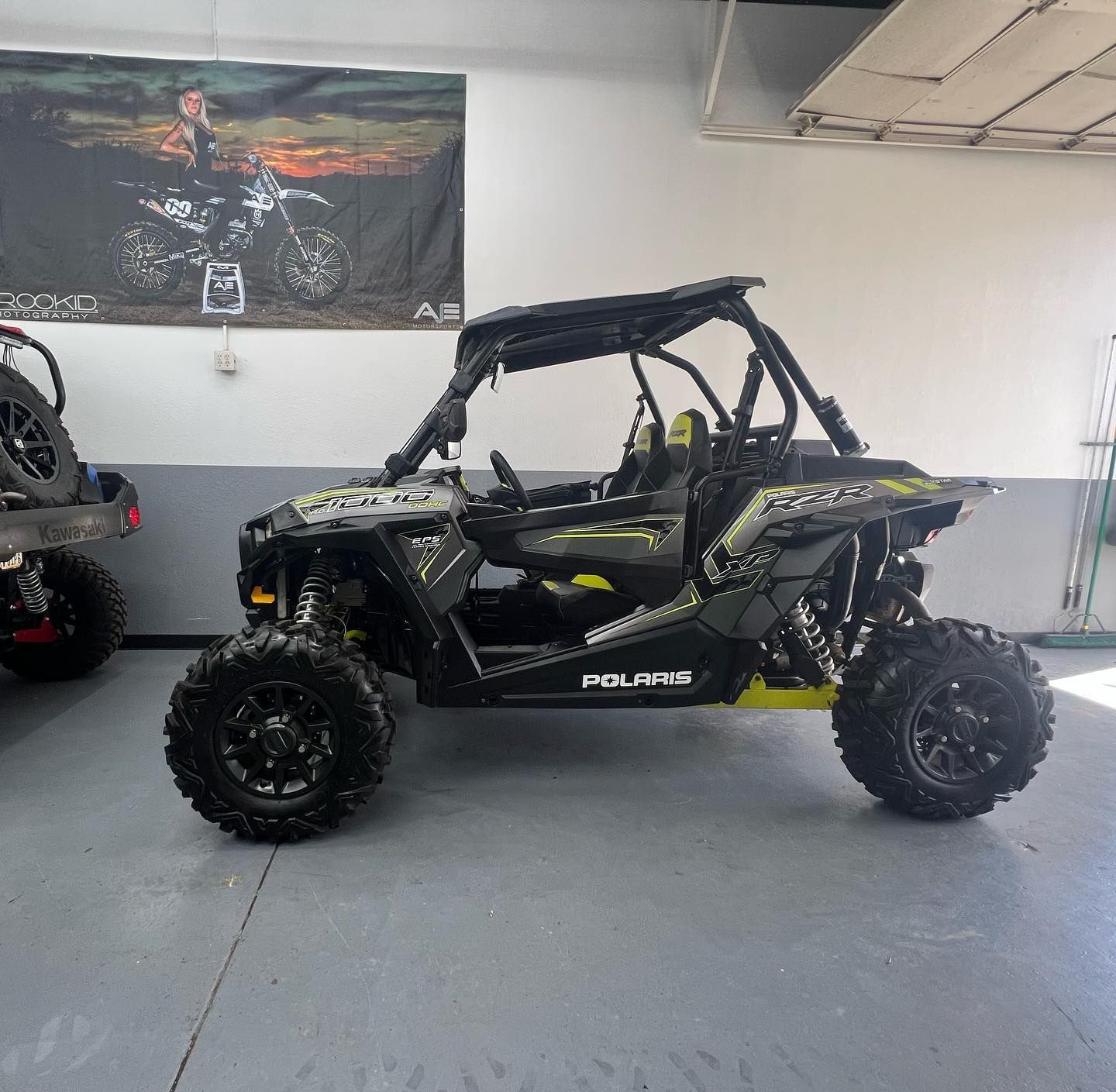 A polaris atv is parked in a garage