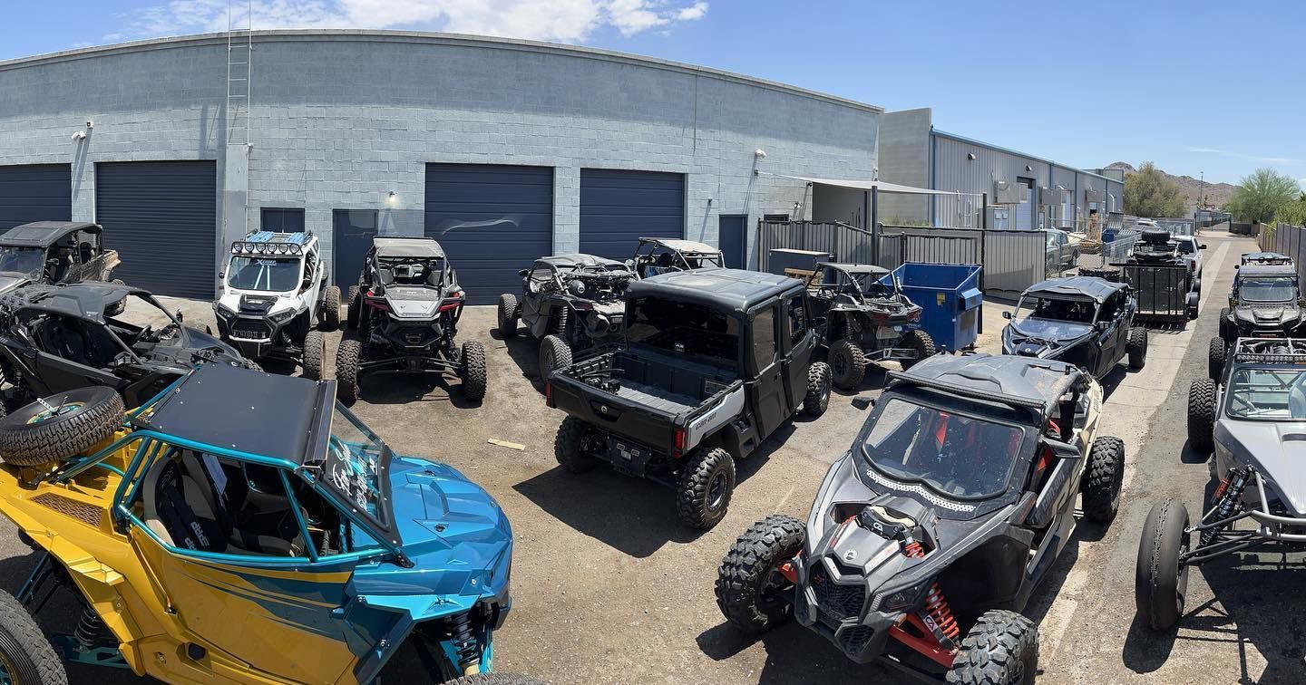 A bunch of atvs are parked in front of a building.