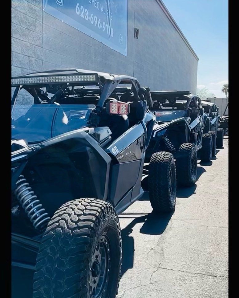 A row of atvs are parked in front of a building.