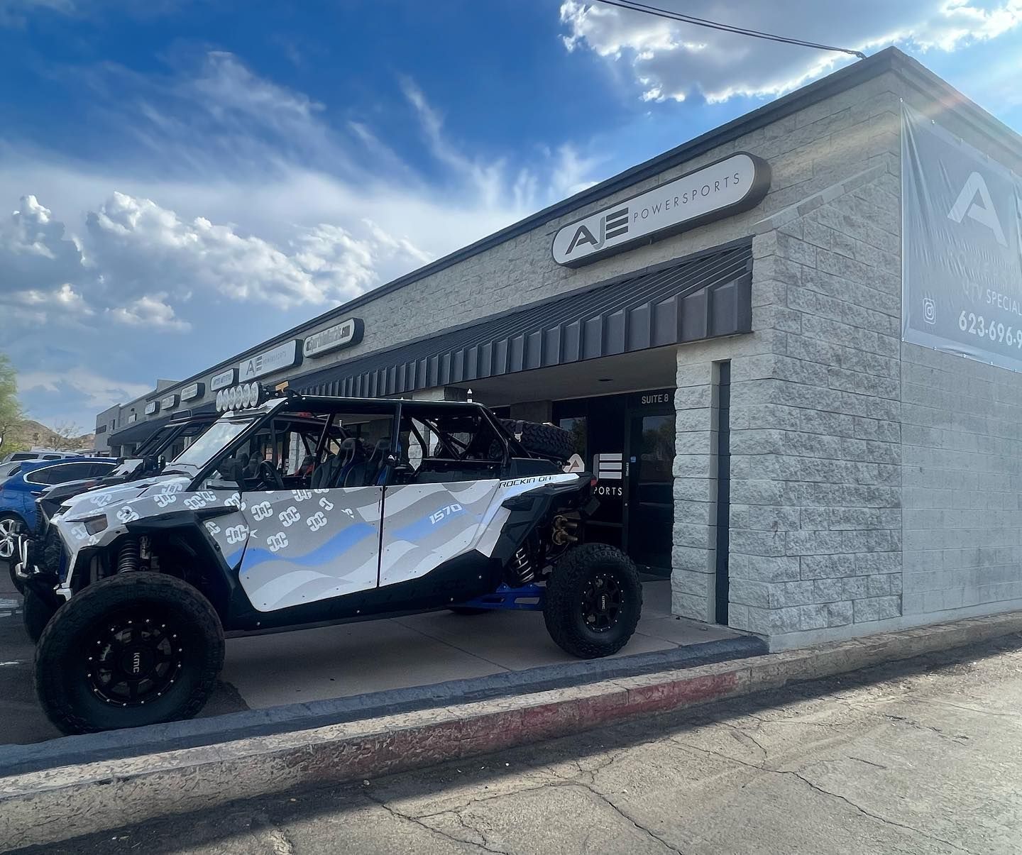 A white atv is parked in front of a building.