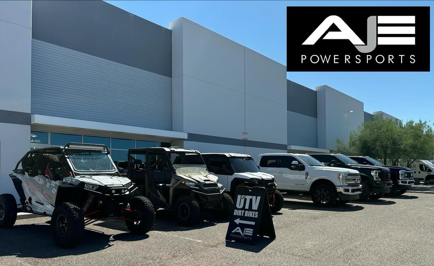 A row of atvs are parked in front of a building.