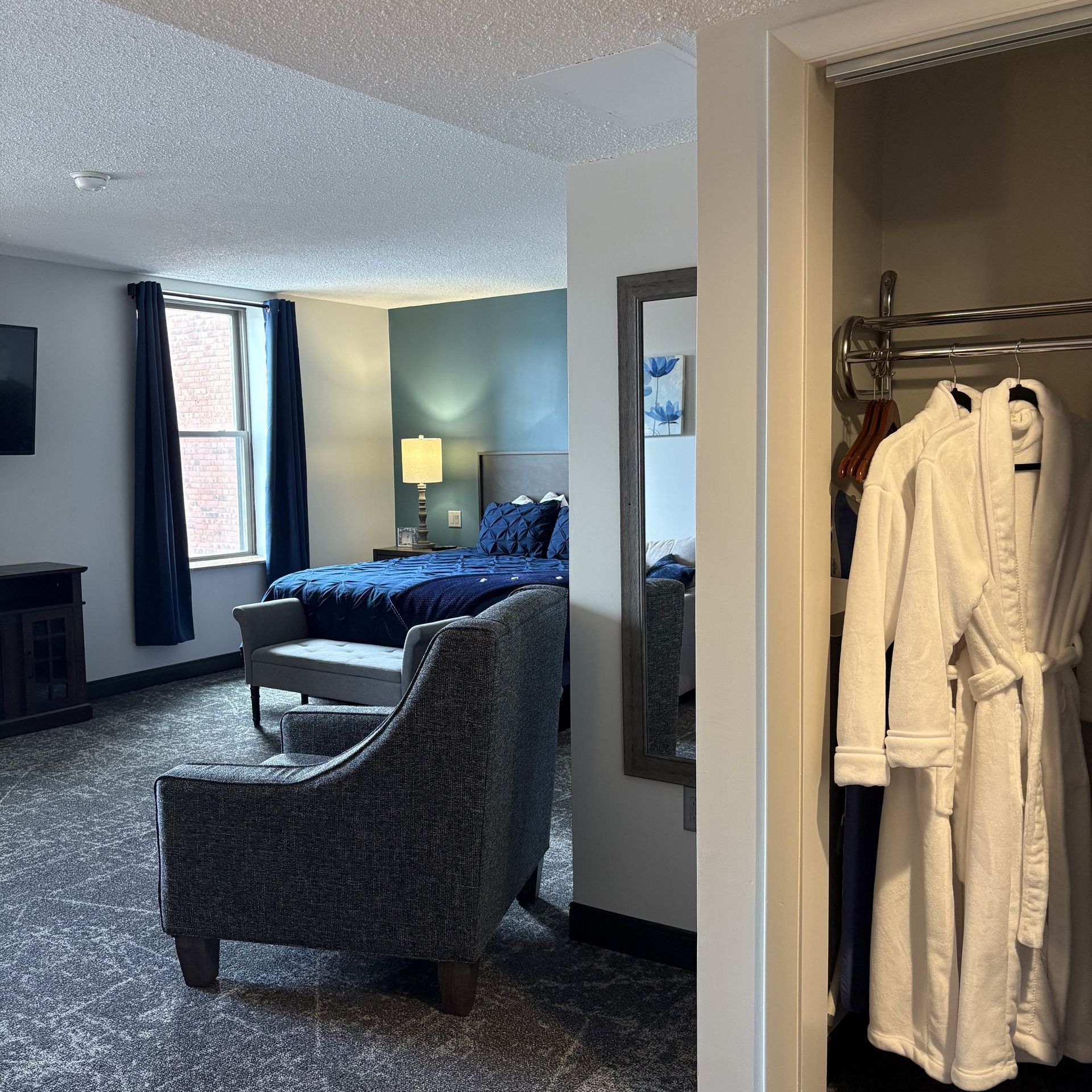 A hotel room with a king size bed and a couch