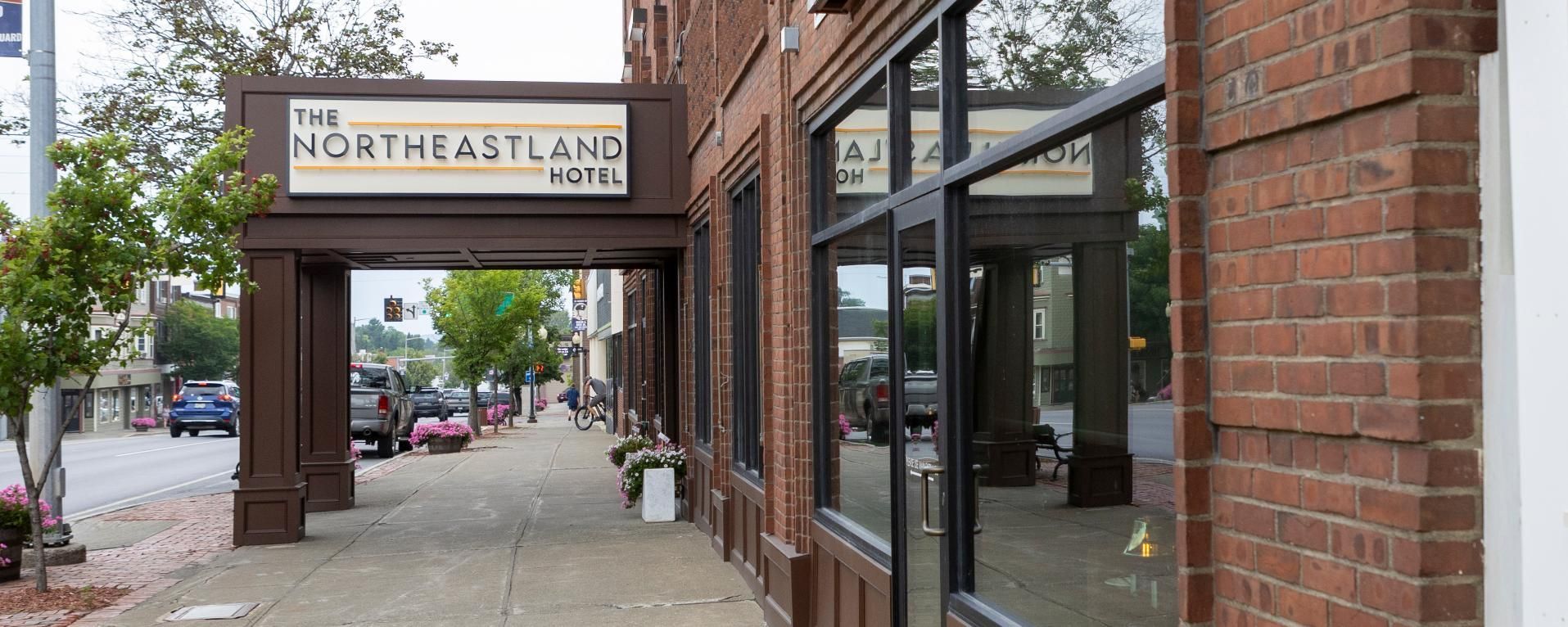 A brick building with a sign that says northeastland hotel
