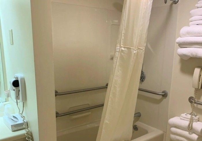 A bathroom with a shower curtain and a bathtub.