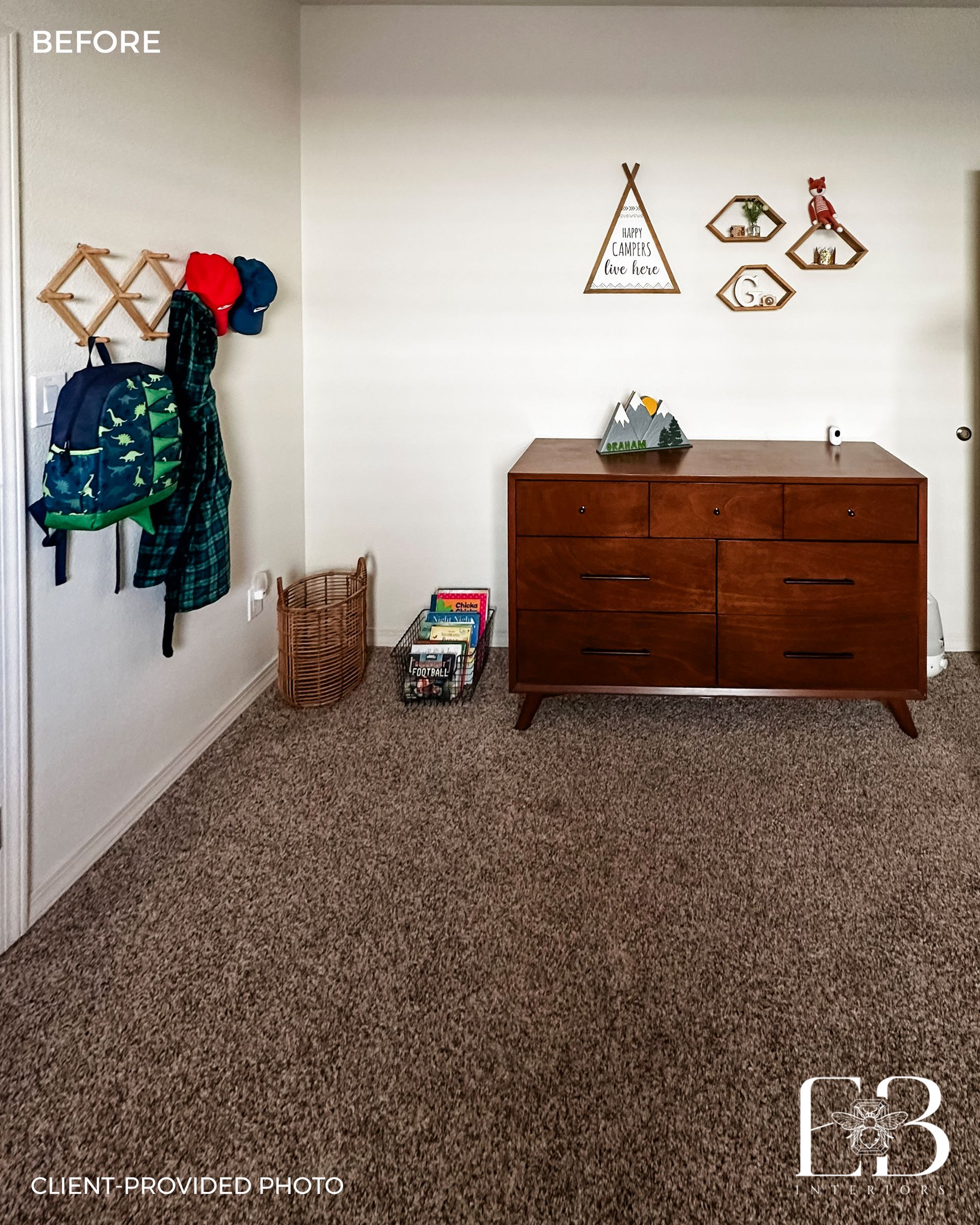 Room with brown carpet, dresser, wall decor, and a coat rack with backpacks.
