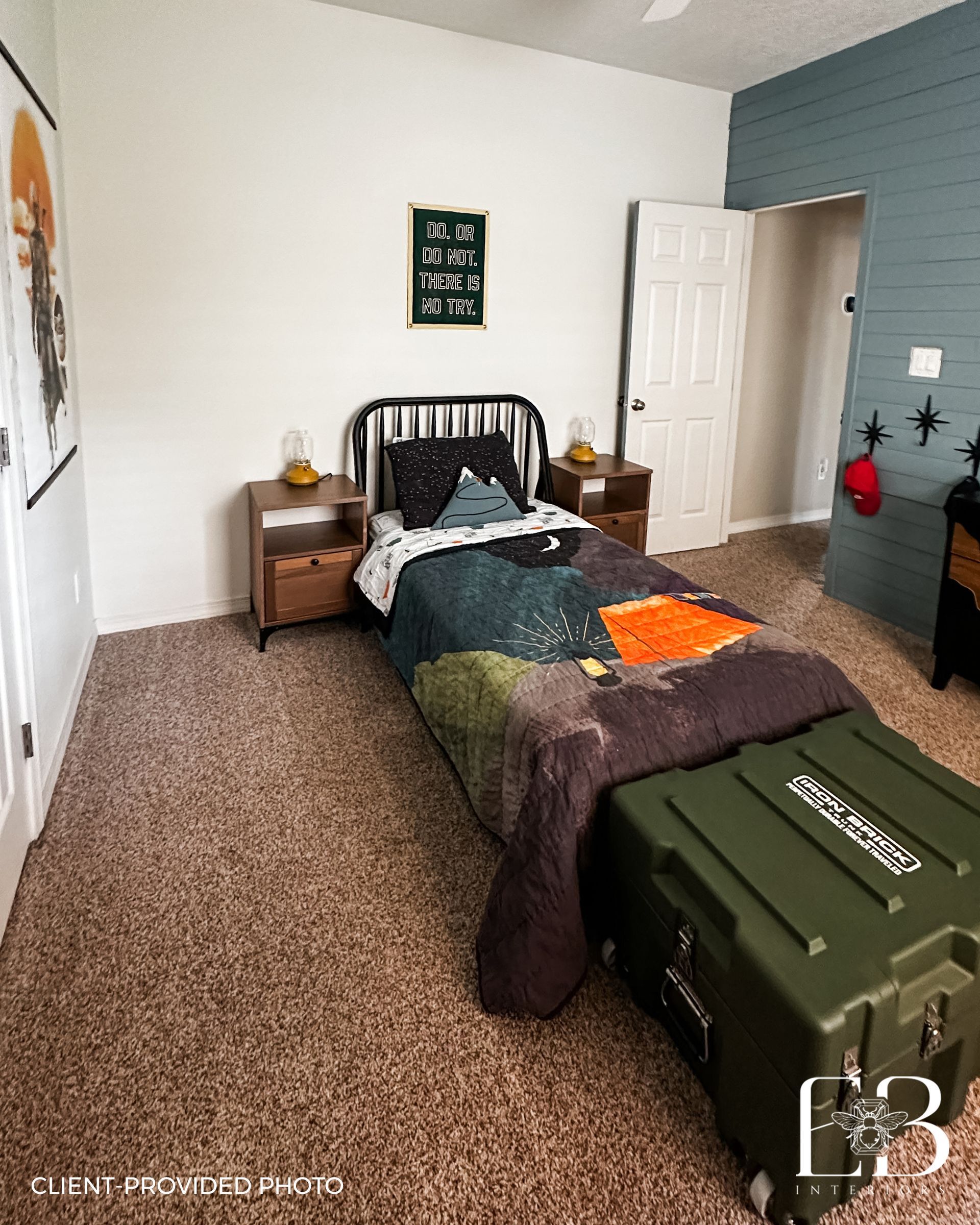 Bedroom with bed, nightstands, and storage trunk. White walls, patterned bedding, and carpet.